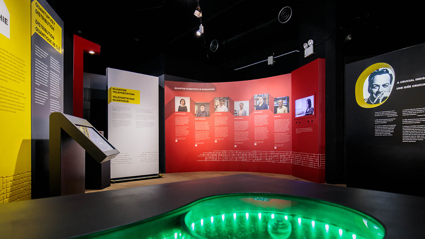 An inside view of Quantum: The Exhibition installed in Singapore, showing a panel that profiles local scientists
