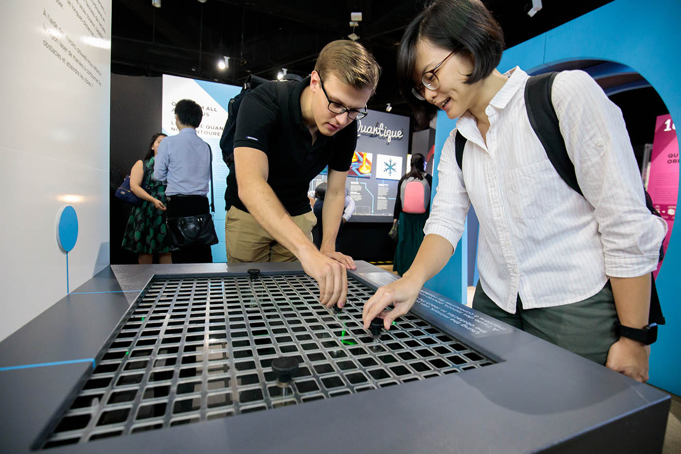 Visitors interacting with quantum exhibits in Science Centre Singapore