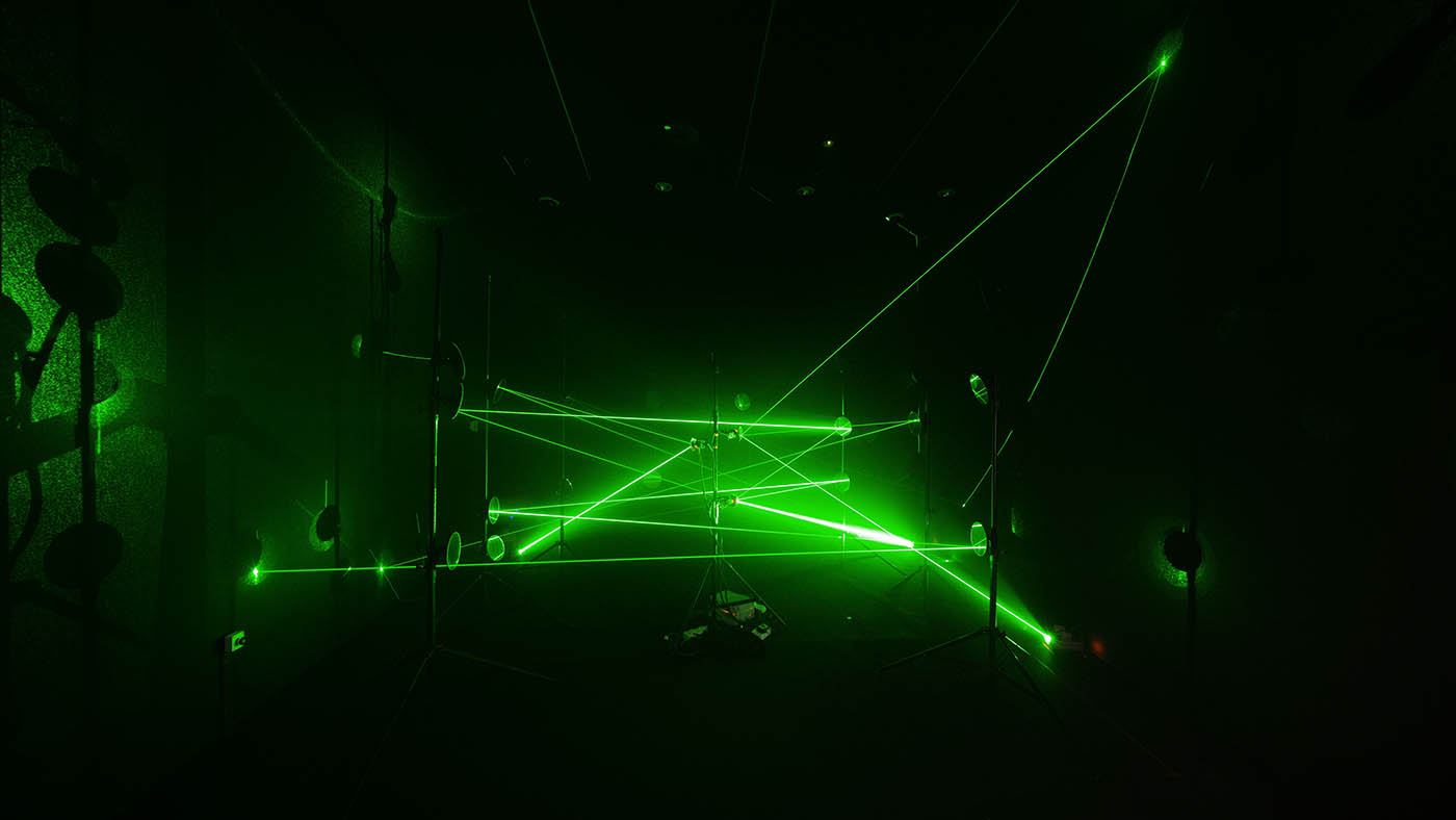 Quantum by Jun Ong is an installation artwork that uses green lasers and mirrors to create continuous laser paths