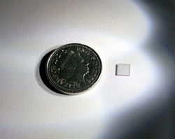 Diamond crystal used in entanglement experiment with a coin for scale