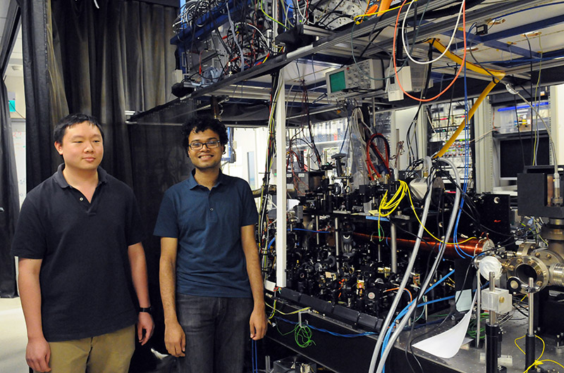 PhD Students Sambit Pal and Mark Lam with a cold fermion experiment at the Centre for Quantum Technologies.