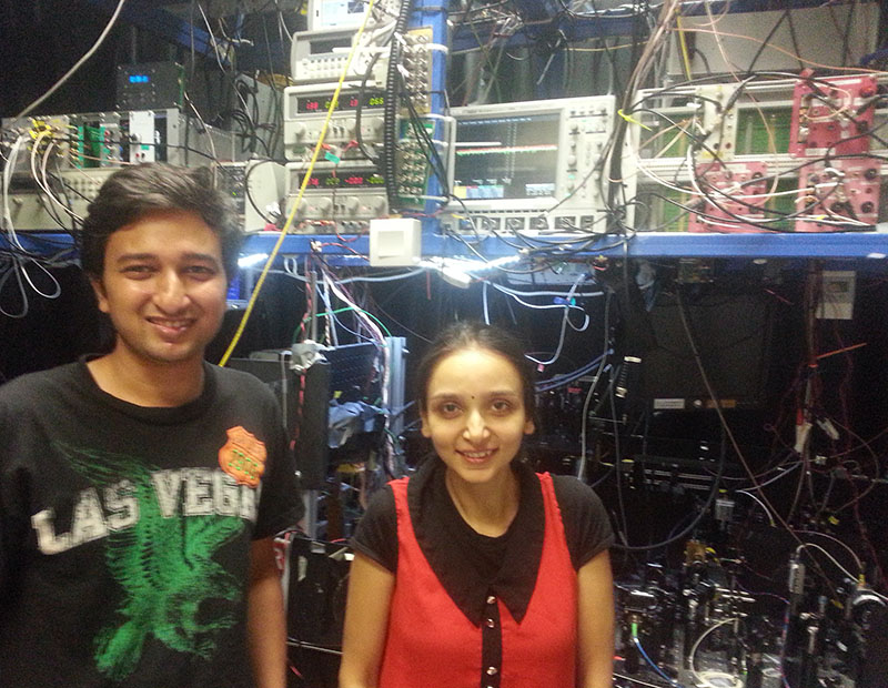 PhD students Bharath Srivathsan and Gurpreet Kaur Gulati with their experiment at the Centre for Quantum Technologies in Singapore
